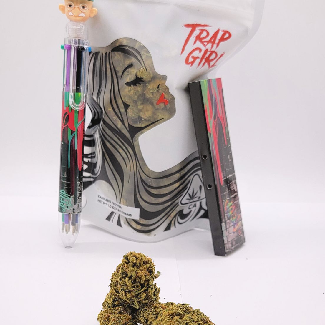 *Deal! $105 1 oz. Dosi Cake (27.98%/Indica) - Trap Girl + Multi-Color Pen + Rolling Papers
